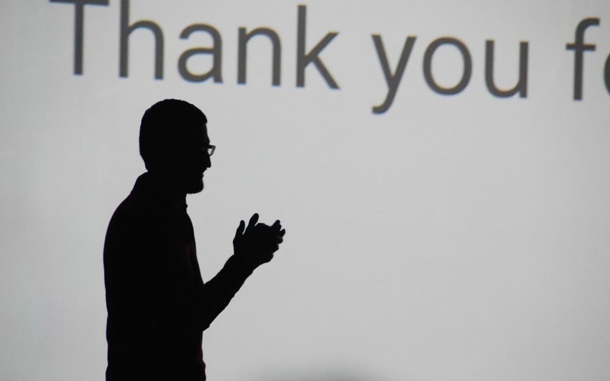 Silhouette of Sundar Pichai speaking onstage at Google I-O